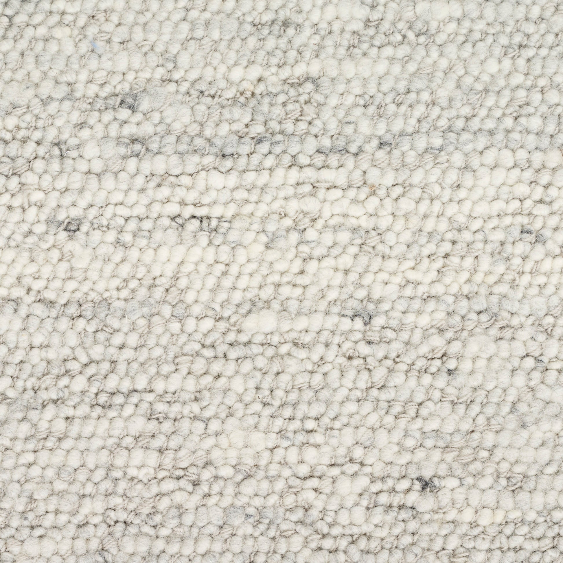 Cream boucle rug close-up with dense loop pile and subtle gray specks, soft textured surface.