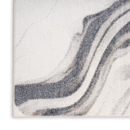 Neutral abstract woven rug with marbled gray and black waves on a cream background.