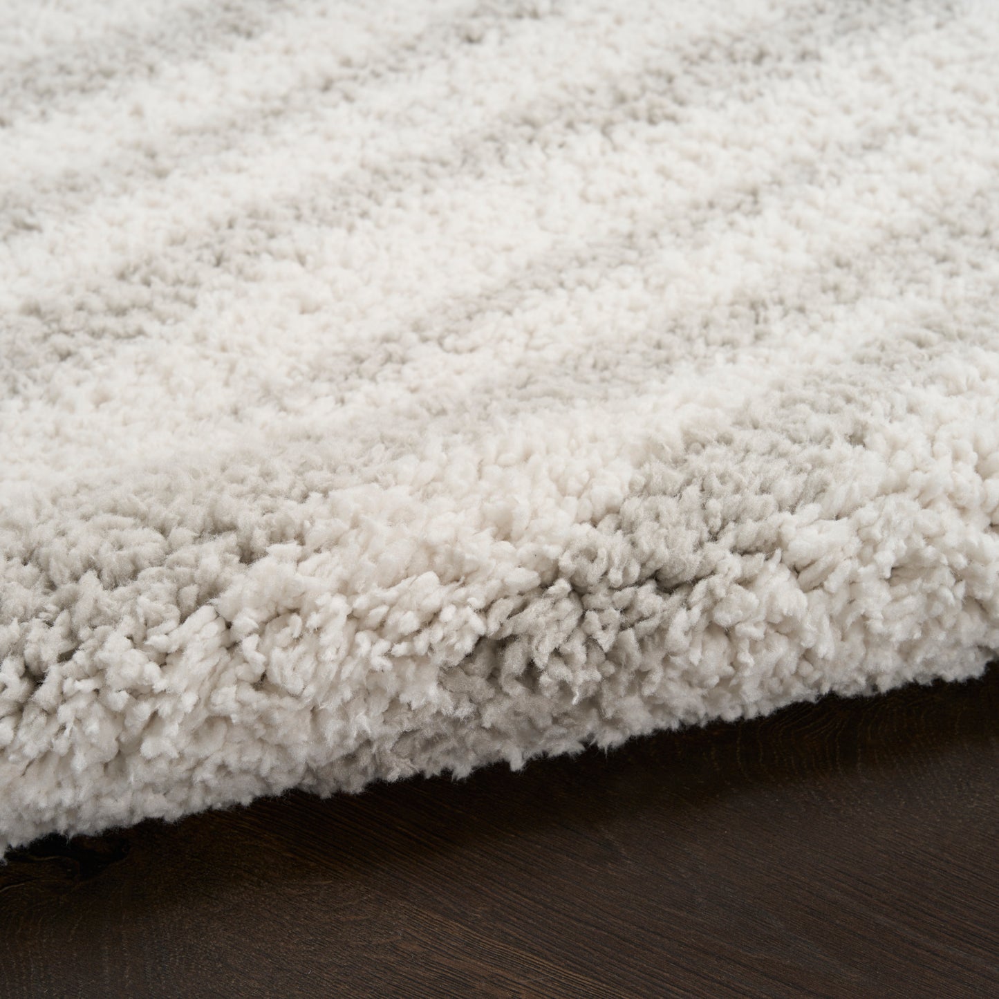 Cream ivory shag rug with dense, fluffy pile on dark wood floor for cozy, modern decor.