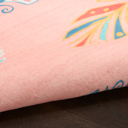 Soft pink rug with colorful abstract shapes in orange, yellow and blue; fuzzy texture, 4' x 5'.
