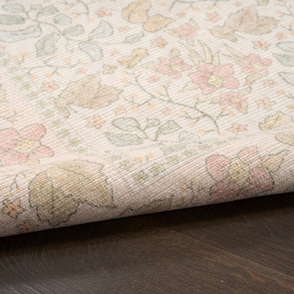 Pastel floral woven rug on ivory with pink & peach & sage blossoms; folded edge on dark wood.