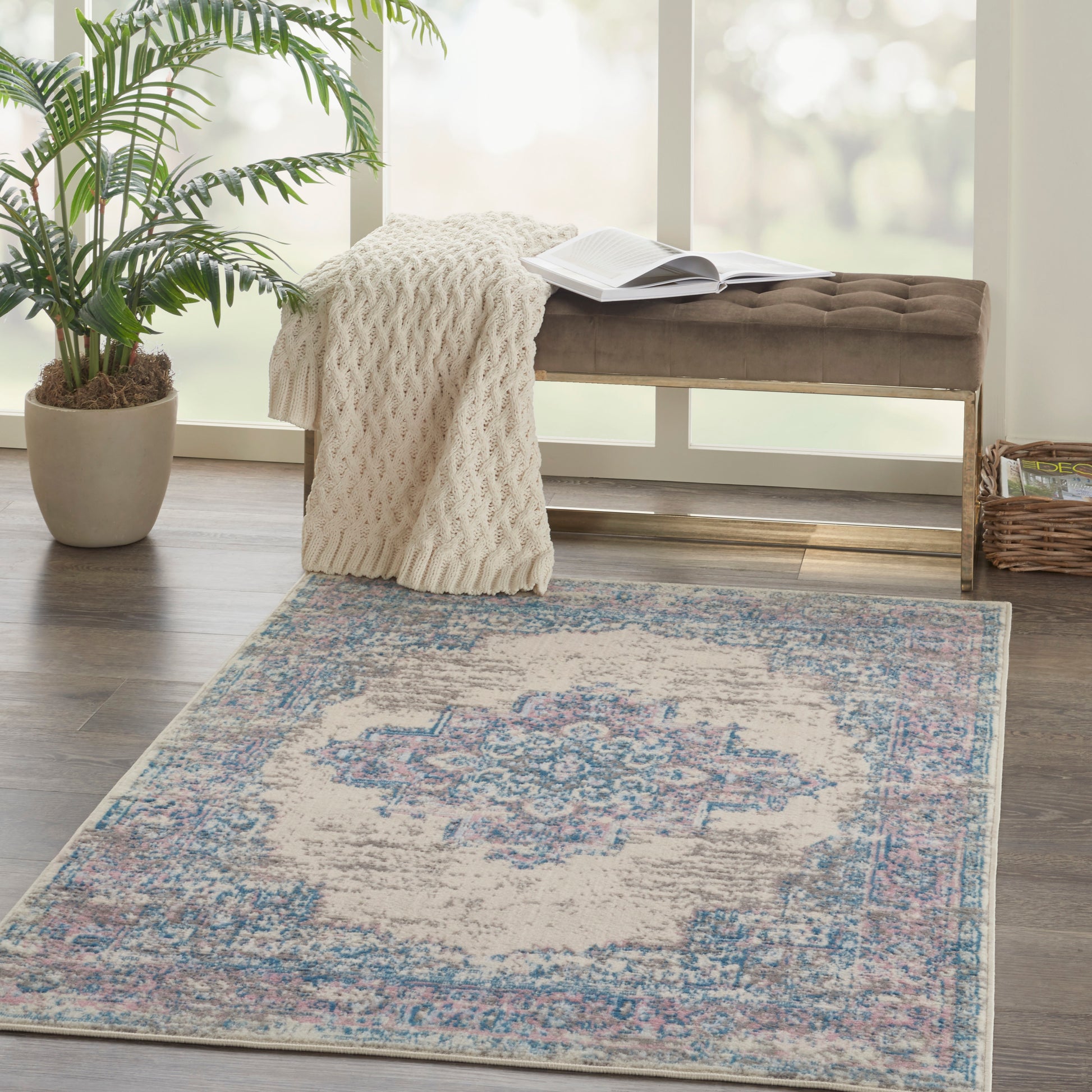 Soft cream distressed area rug with pink and blue oriental-inspired medallion motif for living rooms.