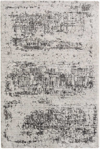 Light gray distressed area rug with irregular charcoal patches, modern style & soft textured pile.