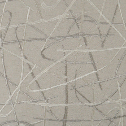 Beige fabric with random light-gray scribble lines creating an abstract, embroidered look.