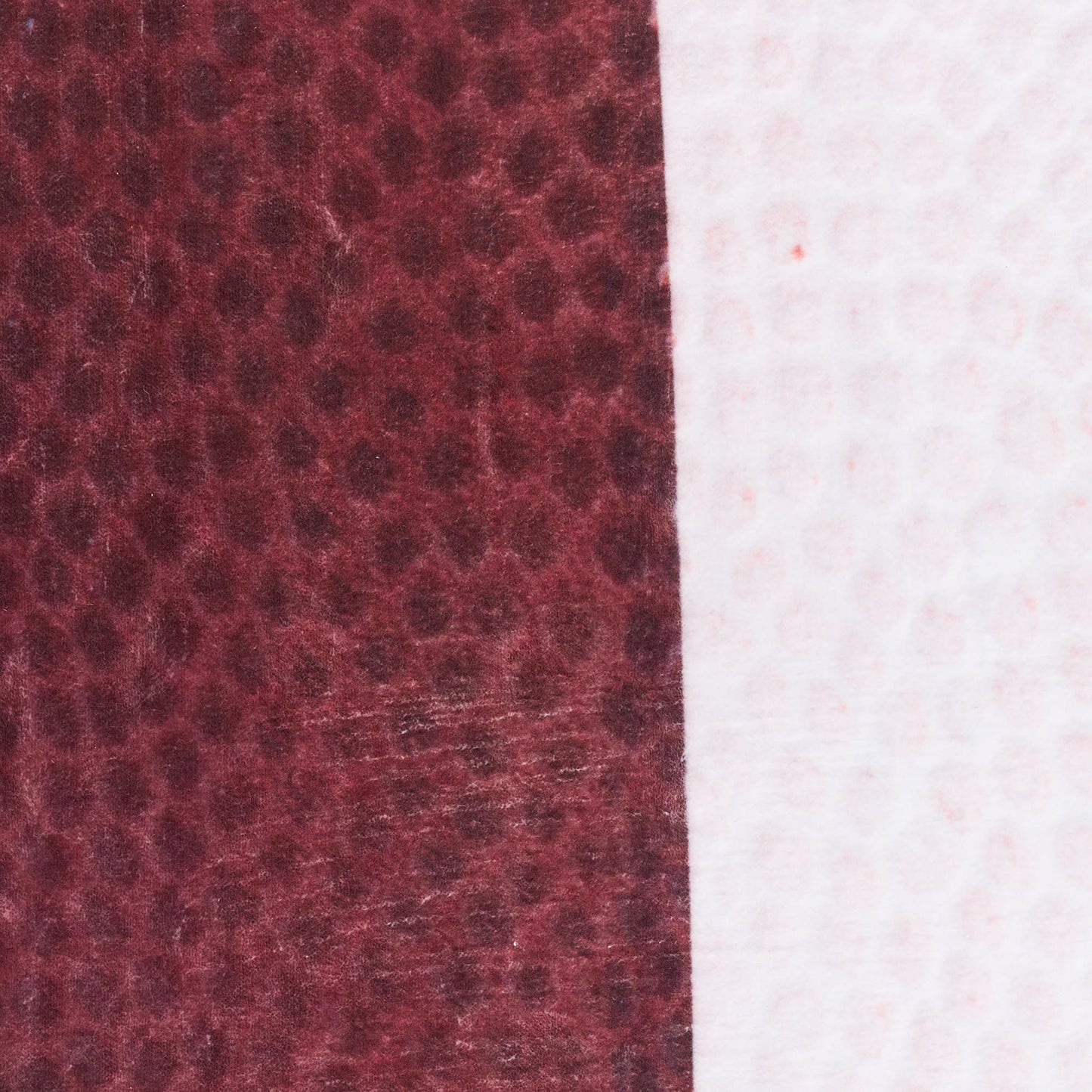 Two-tone fabric swatch: burgundy leather-like texture on left and pale pink fabric on right, vertical seam.