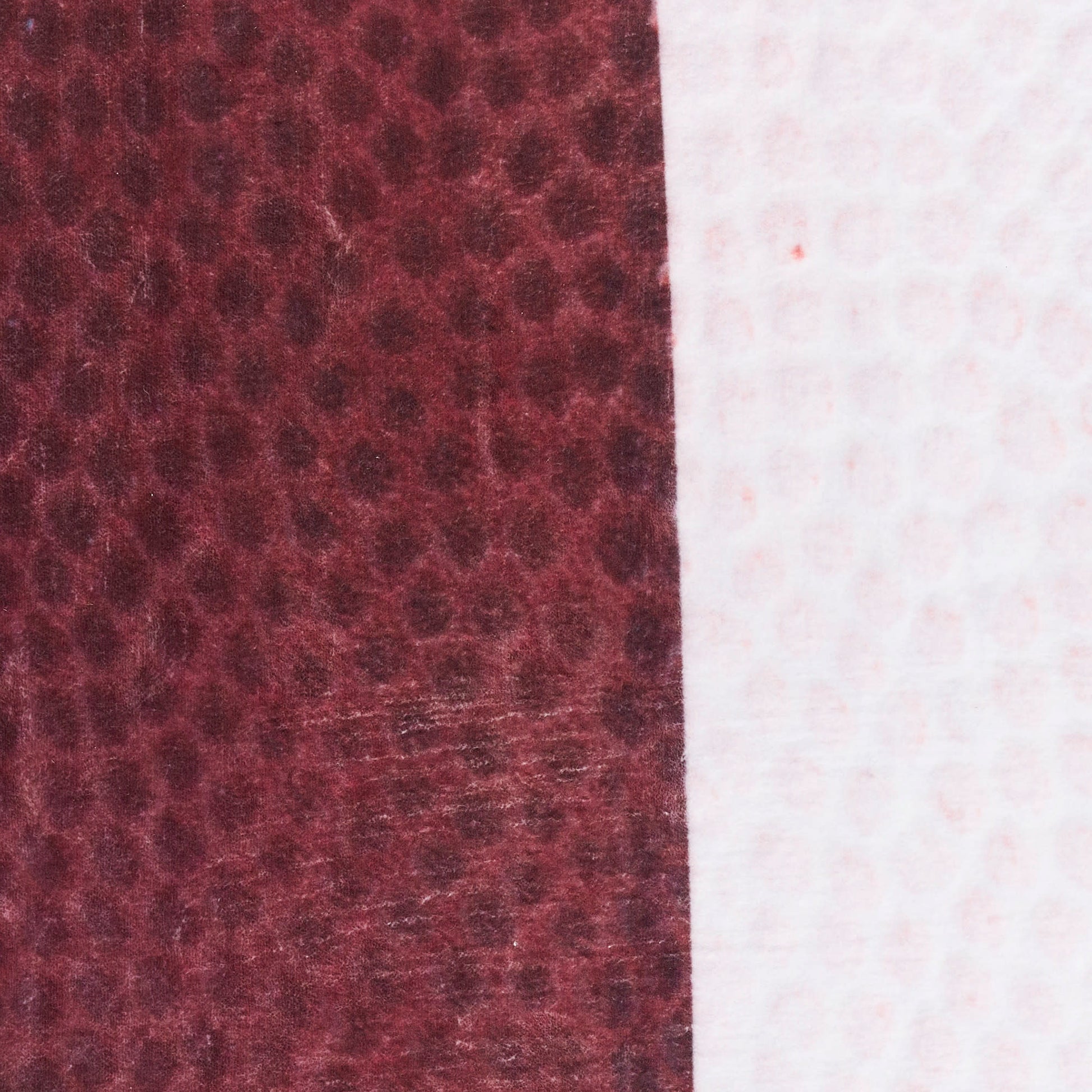 Two-tone fabric swatch: burgundy leather-like texture on left and pale pink fabric on right, vertical seam.