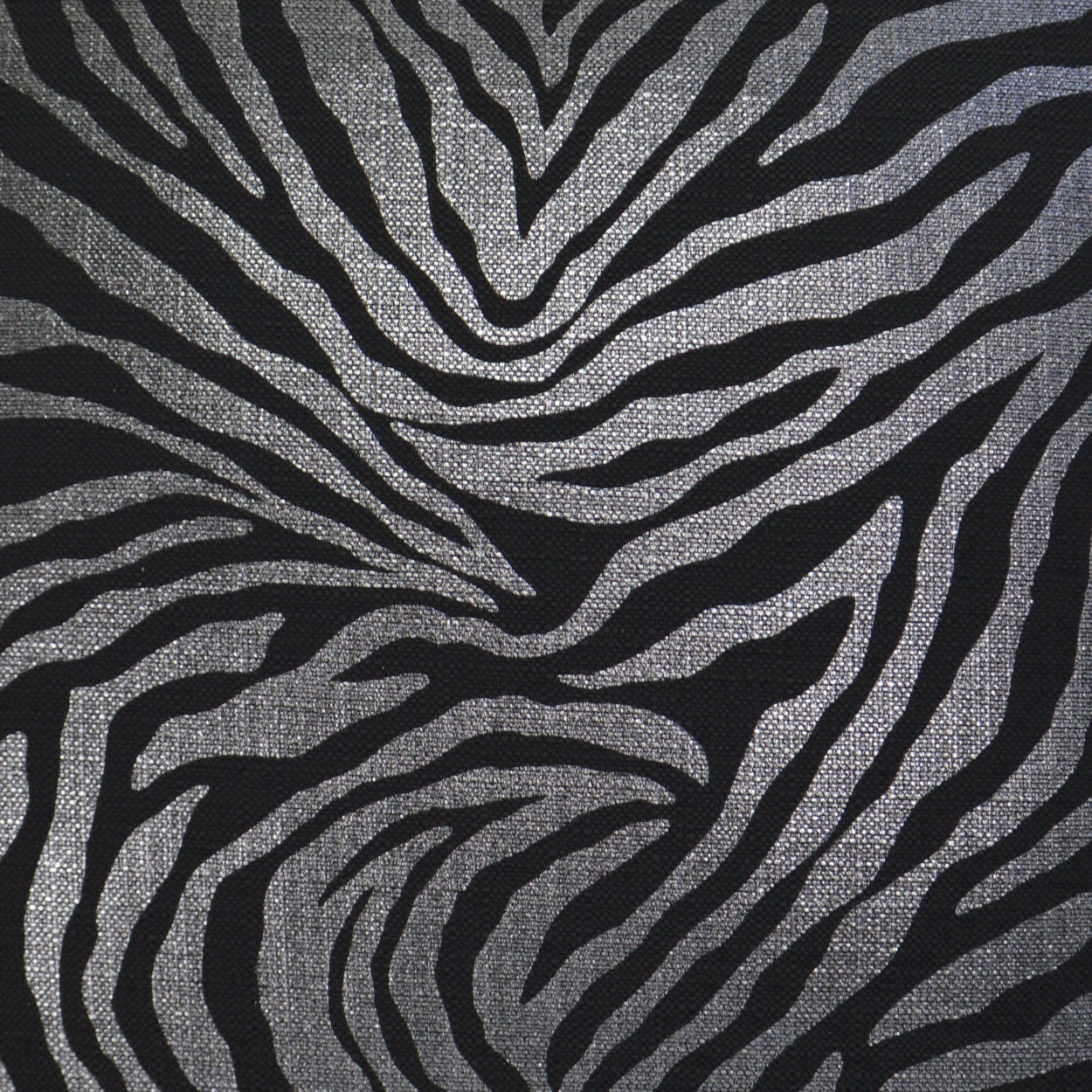 Zebra-striped fabric with metallic silver bands on a black background.