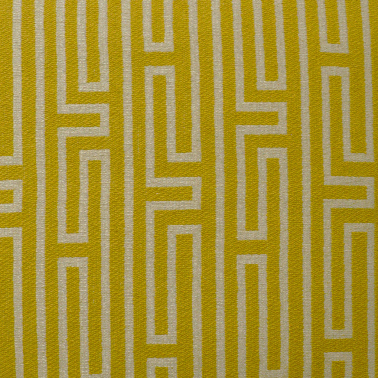 Yellow and white maze-patterned fabric with interlocking rectangular lines; modern geometric upholstery or home decor textile.