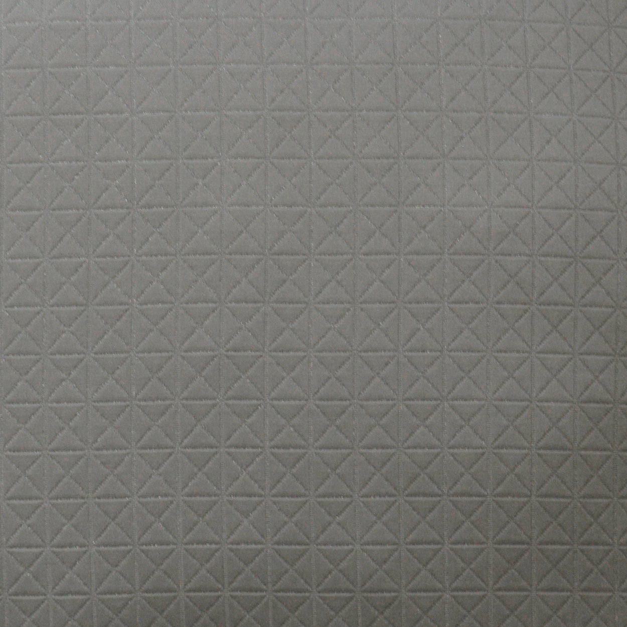 Light gray pillow with a subtle quilted grid of small X-shaped stitches.