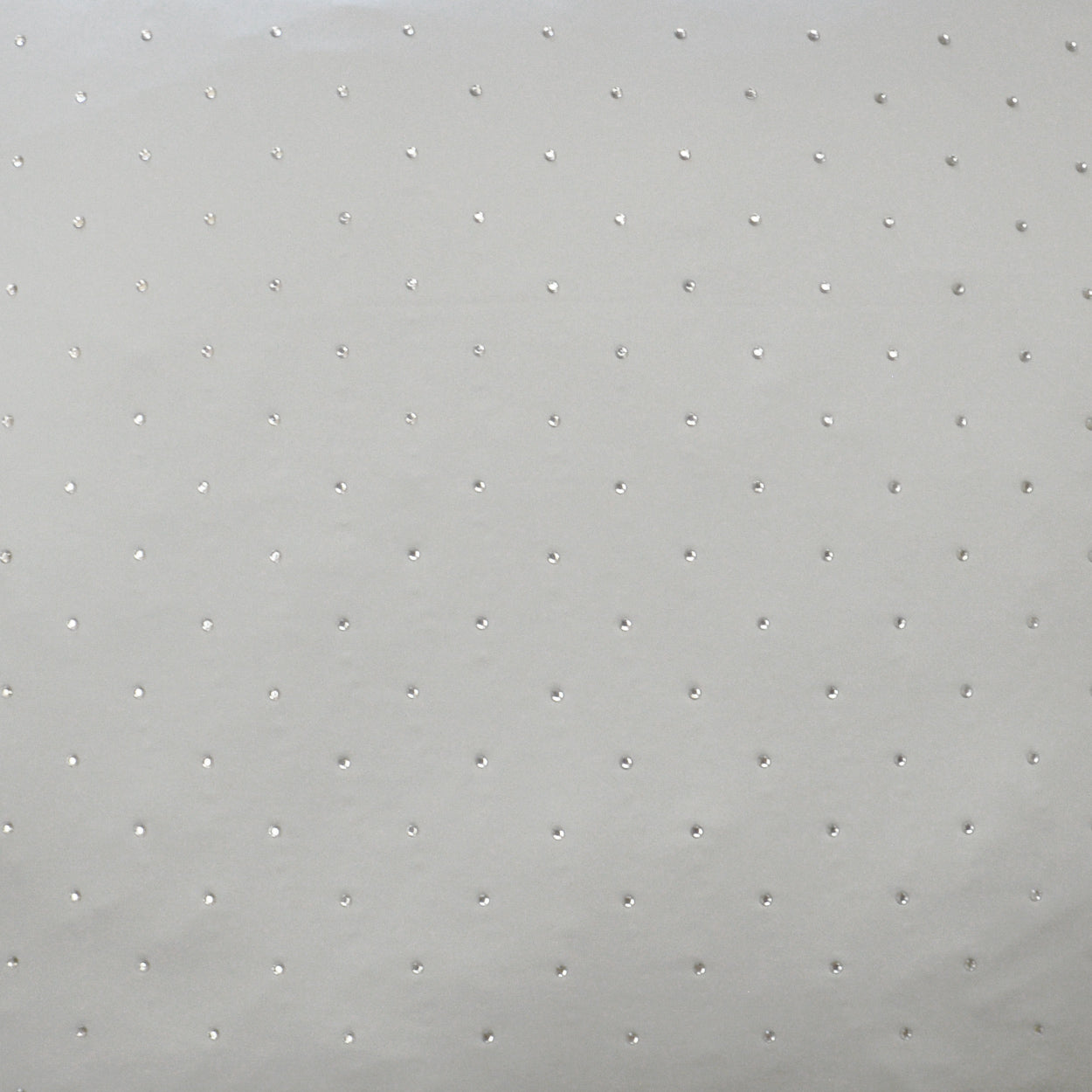 Light gray fabric with tiny raised dots in a regular grid; textured dotted upholstery or apparel material.