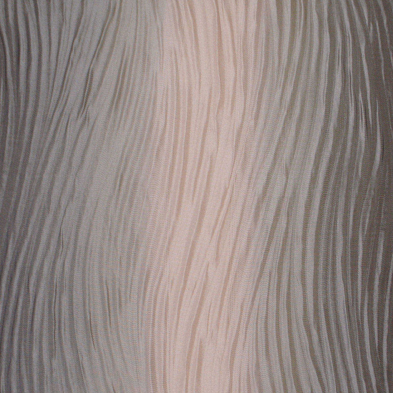 Close-up of pink textured pillow fabric with pleated, wavy vertical lines.