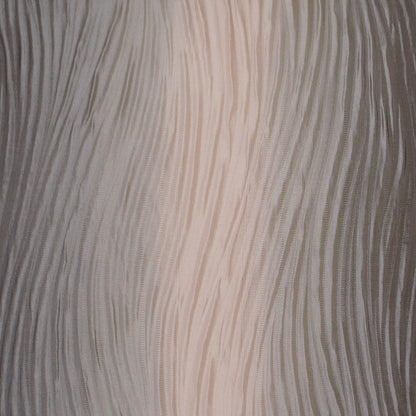 Close-up of pink textured pillow fabric with pleated, wavy vertical lines.