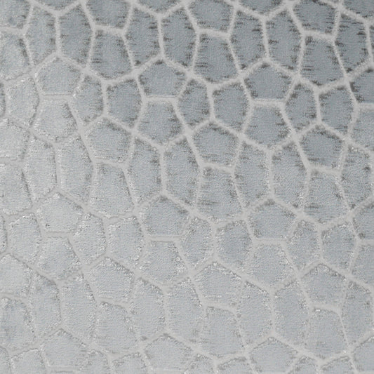 Light grey fabric with white raised irregular polygon mosaic pattern; giraffe-like textured upholstery surface.