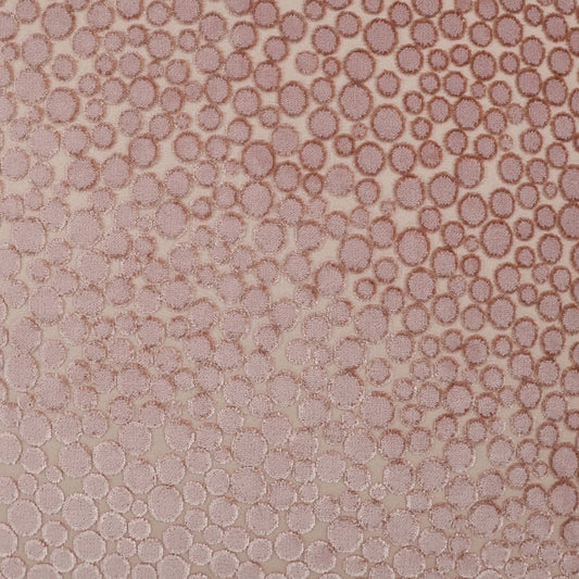 Rose-pink textured fabric with dense circular bubble pattern and subtle shimmer.
