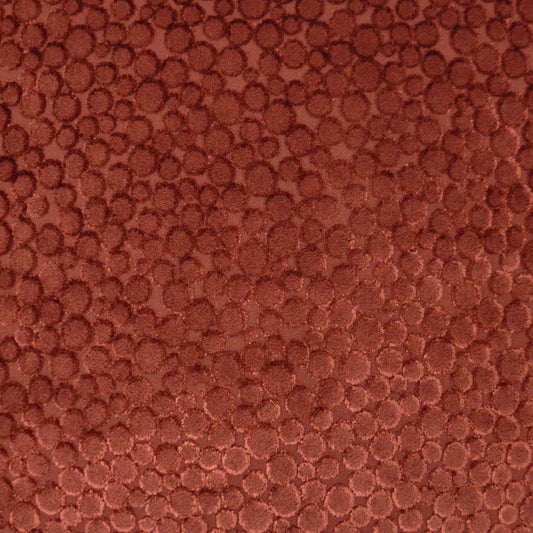 Close-up of reddish-brown pebble-grain leather texture with rounded bumps.