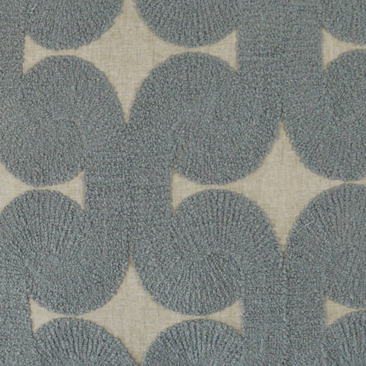 Blue-gray circular tufted rug pattern on beige background; modern geometric textile.