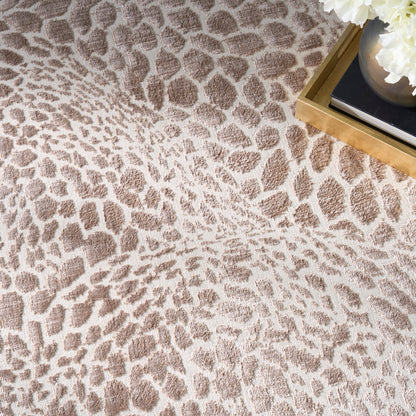 Beige leopard-print rug with plush texture & tan spots, gold tray, books & white flowers decorate the corner.