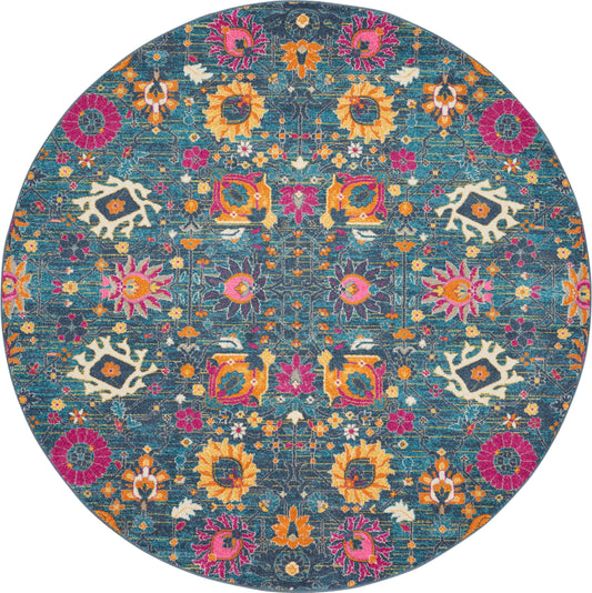 Round teal rug with vibrant multicolor floral pattern; orange, pink & yellow flowers with white accents.