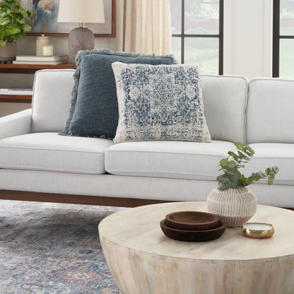 Light gray rug with ivory and navy farmhouse pattern on the floor.
