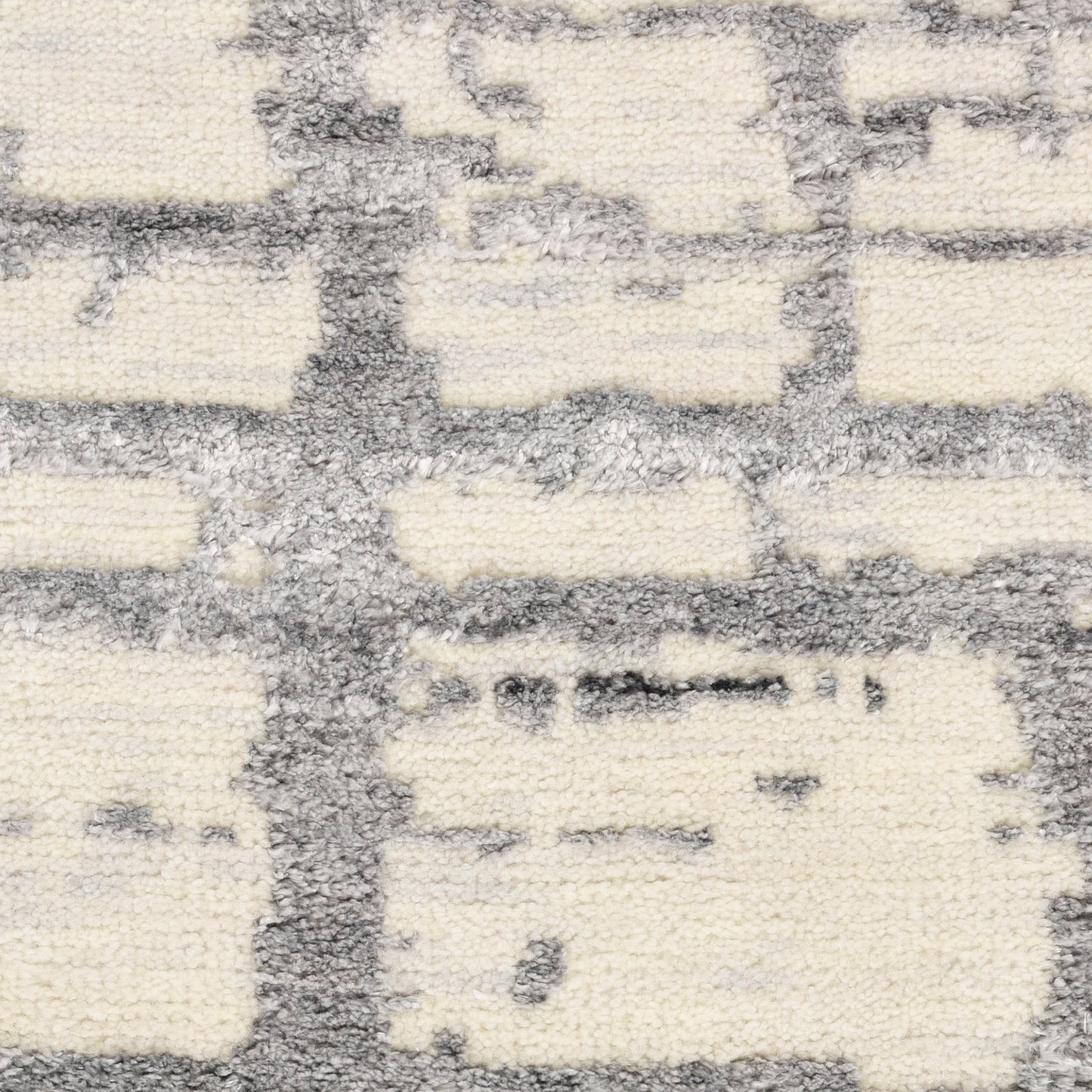 Cream and gray textured rug with a geometric grid pattern in a soft loop pile.