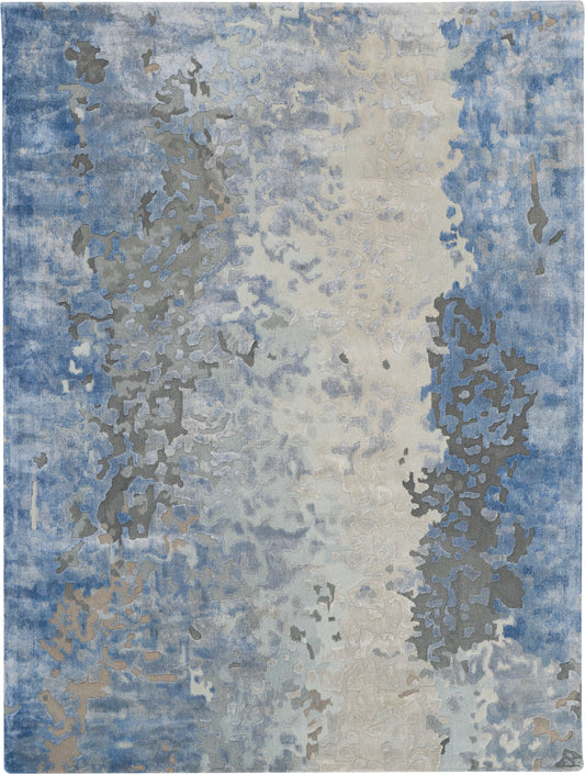 Abstract blue-gray and beige area rug with irregular blotches and a soft, muted gradient.