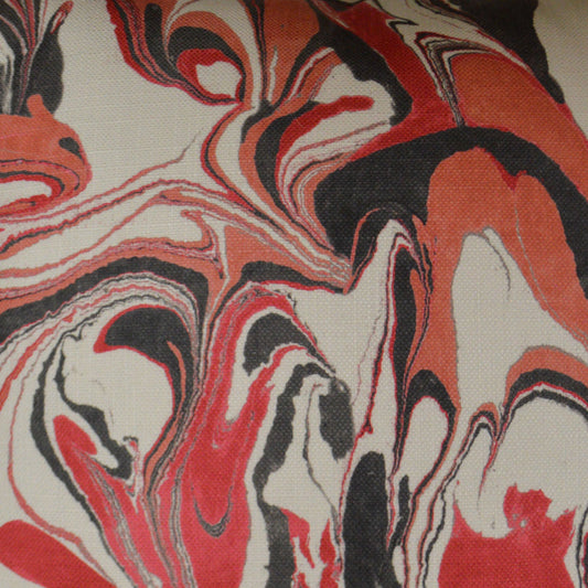 Abstract red, black, and white marbled fabric pattern with flowing swirls; versatile textile for upholstery or home decor.