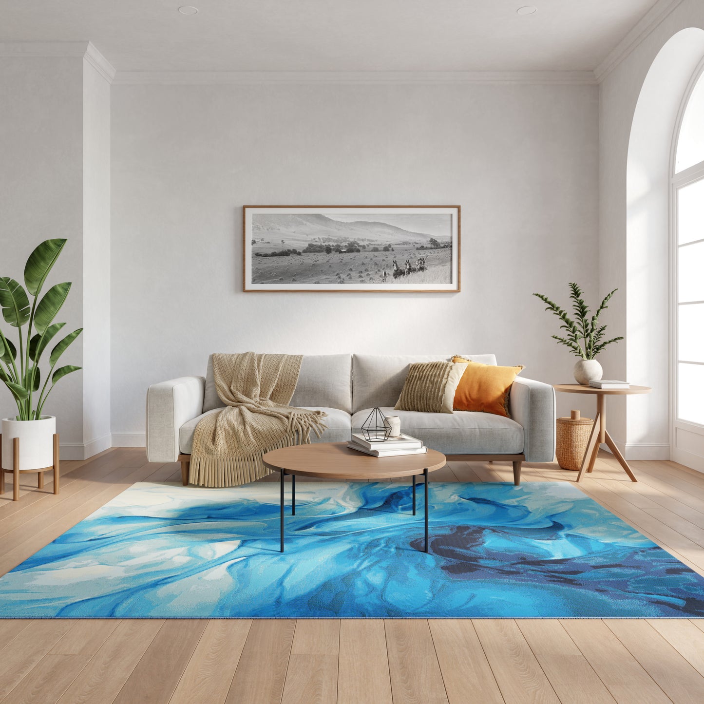 Cozy modern living room with blue abstract rug, light gray sofa, beige throw, orange pillow, round wood coffee table, plants.