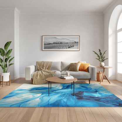Cozy modern living room with blue abstract rug, light gray sofa, beige throw, orange pillow, round wood coffee table, plants.