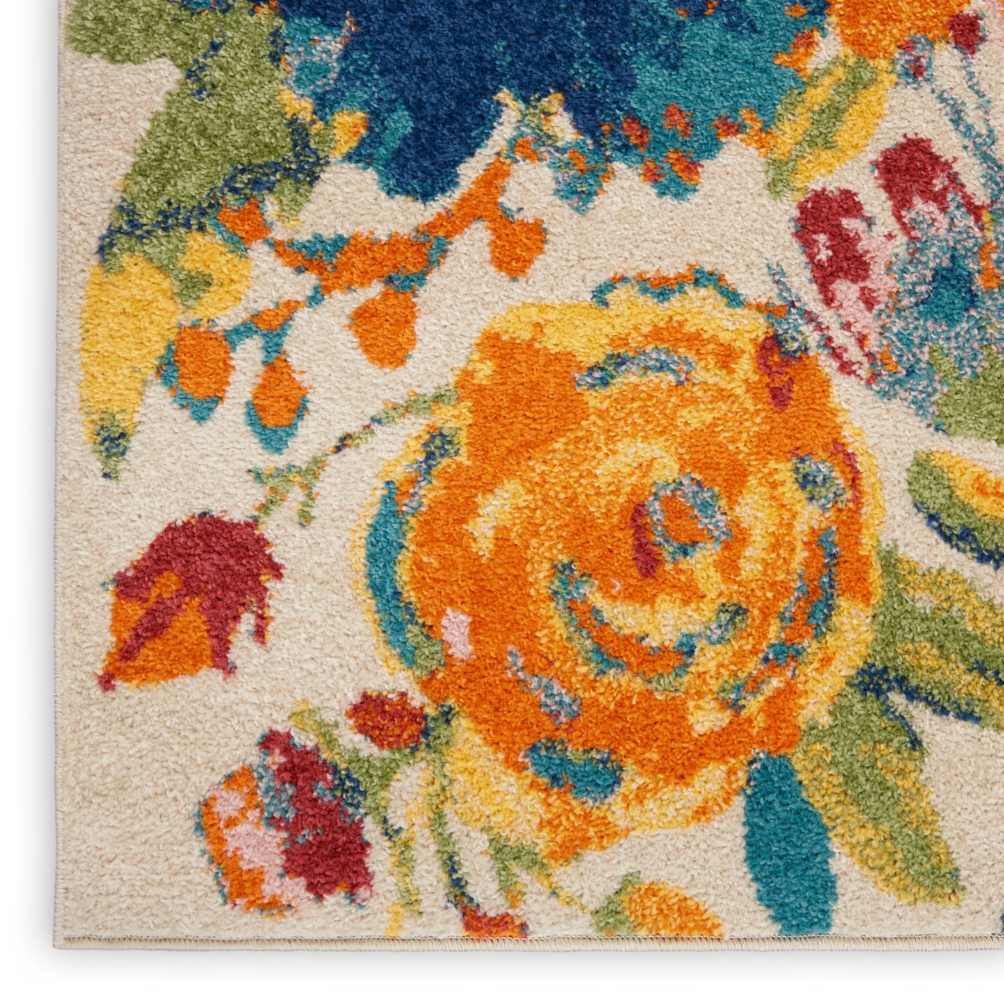 Close-up of a vibrant floral rug with an orange central bloom, blue and yellow accents on a cream background; plush pile.