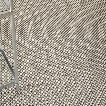 Beige modern rug on a black-and-white lattice floor; 4' x 6'.