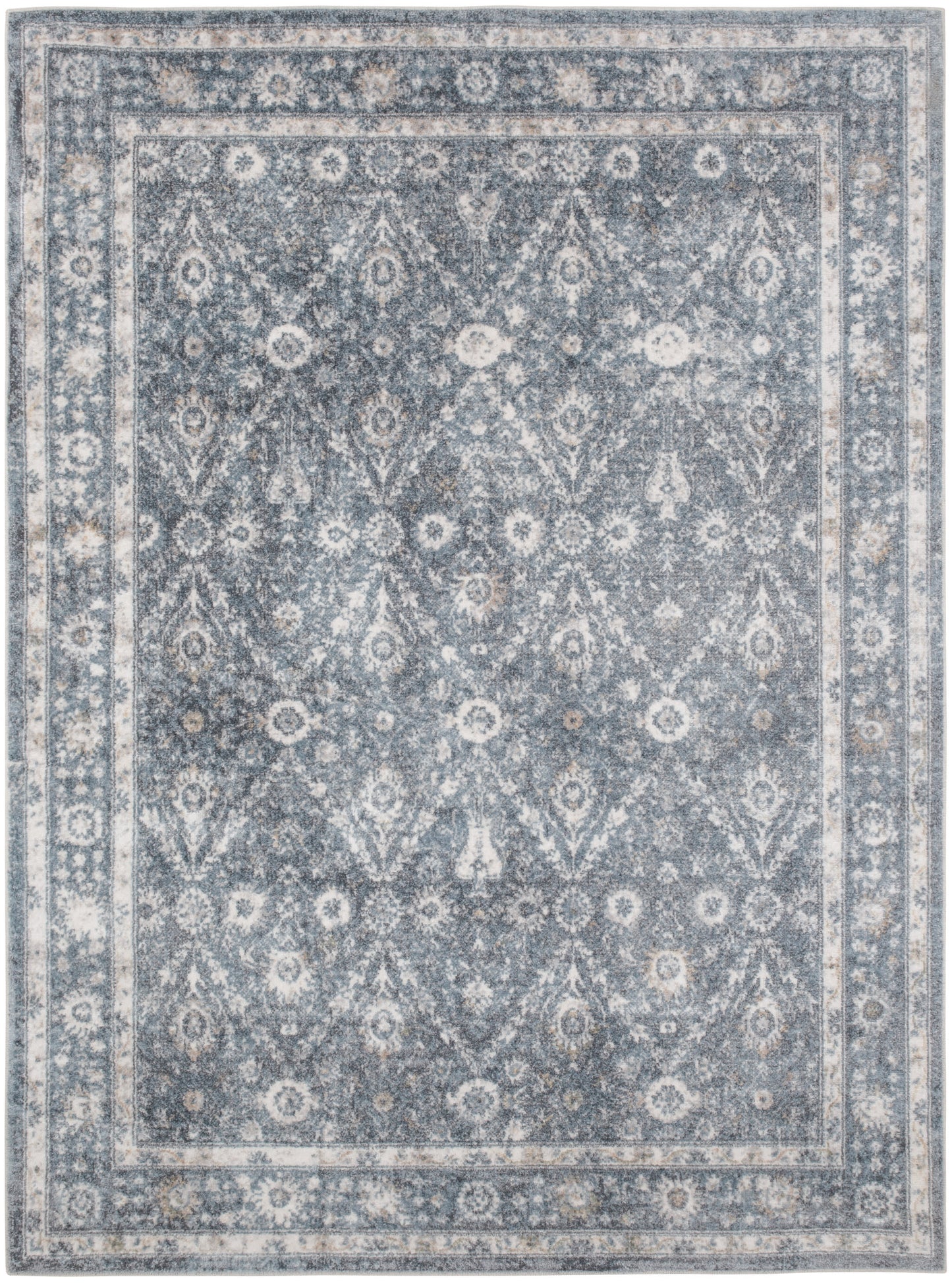 Blue-gray traditional patterned area rug with ivory floral motifs and layered borders, distressed finish, 5' x 7'.