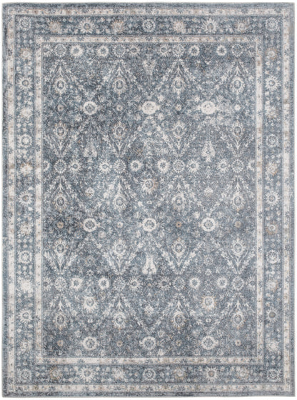 Blue-gray traditional patterned area rug with ivory floral motifs and layered borders, distressed finish, 5' x 7'.