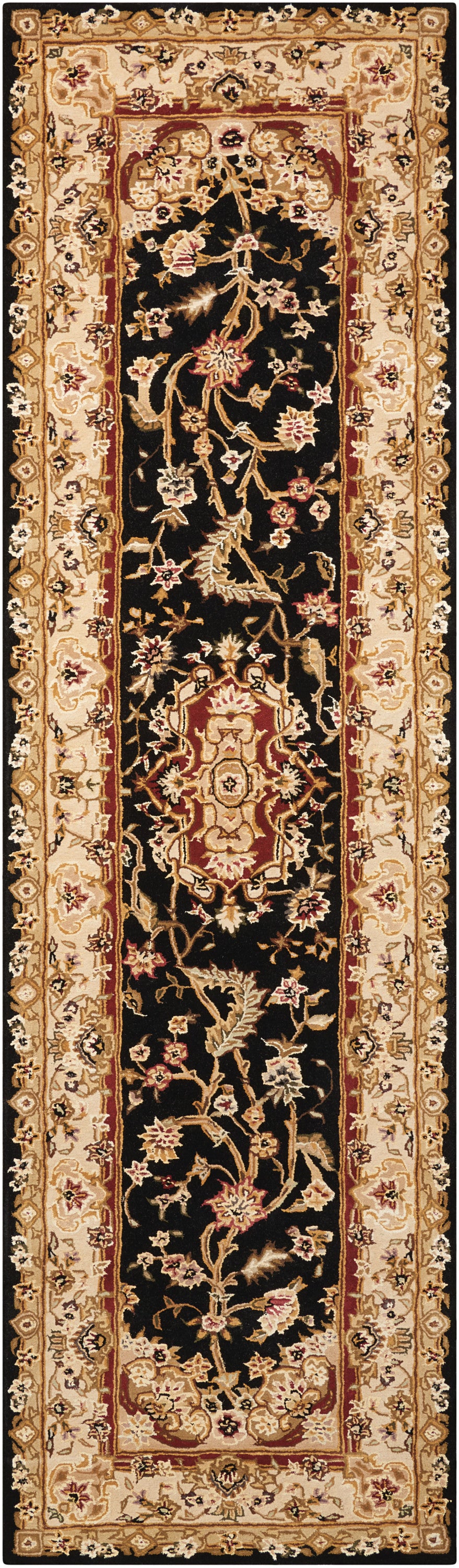 Narrow oriental runner rug with black field, gold-beige floral vines and red central medallion accents; Persian-style hallway decor.