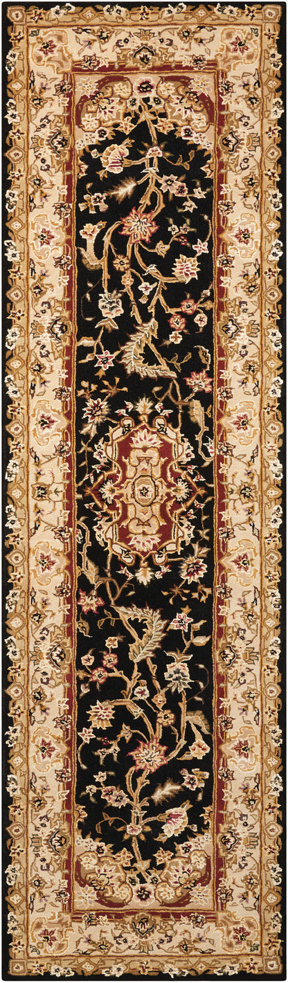 Narrow oriental runner rug with black field, gold-beige floral vines and red central medallion accents; Persian-style hallway decor.