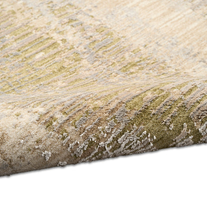 Close-up of a textured abstract rug in olive green, beige and gray with plush, high-pile fibers.