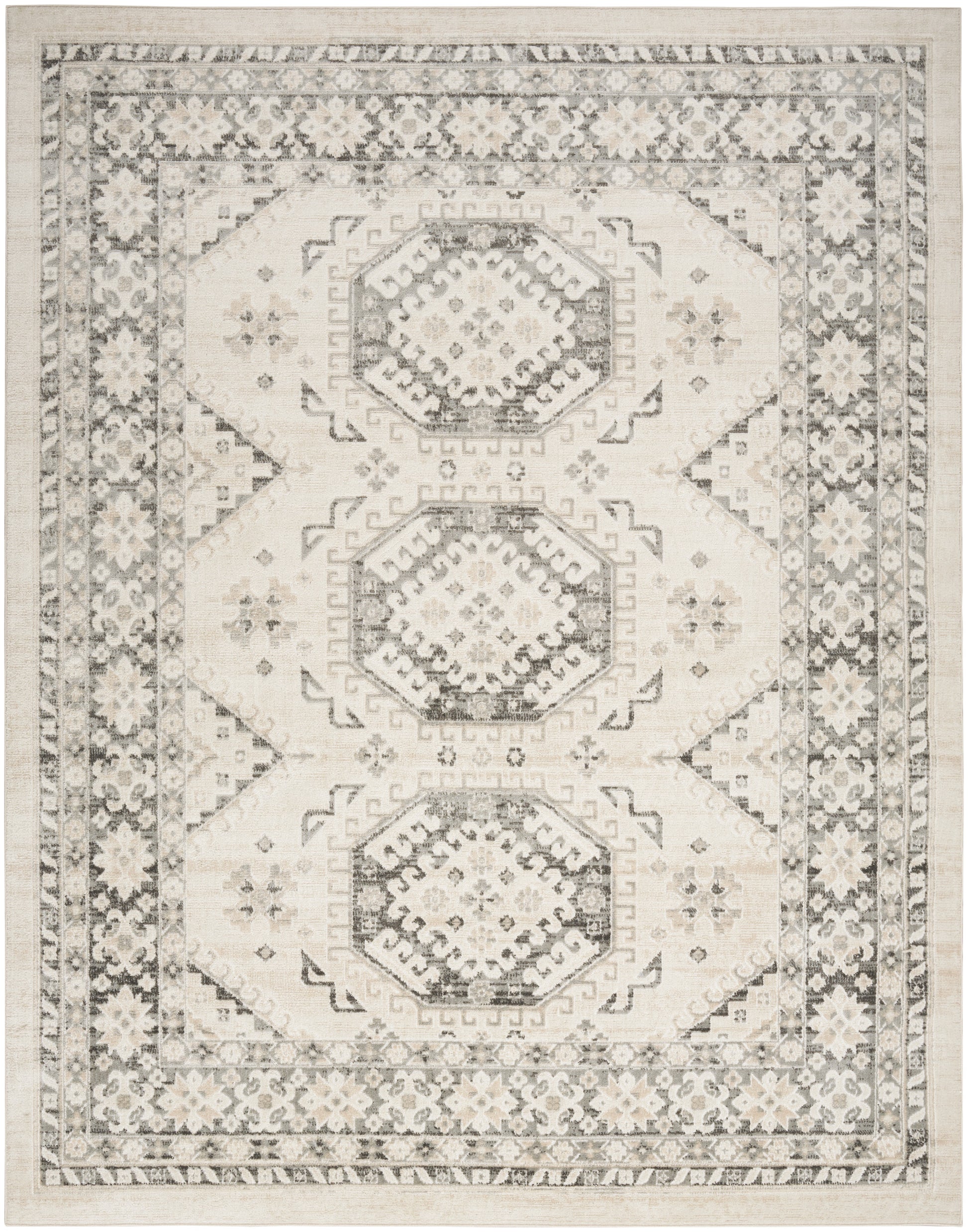 Neutral-toned area rug with three stacked hexagonal medallions, ivory and charcoal pattern, ornate floral border.