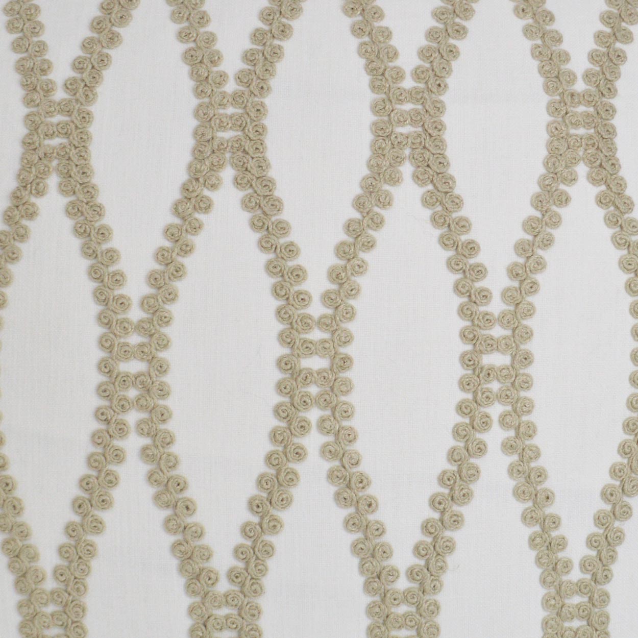 Beige rosette-trim fabric with interlocking diamond lattice pattern; ideal for decor.
