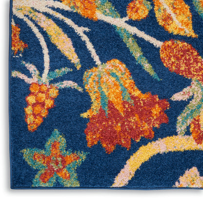 Blue rug with vivid orange and yellow flowers, teal leaves, and cream stems; loop pile texture.