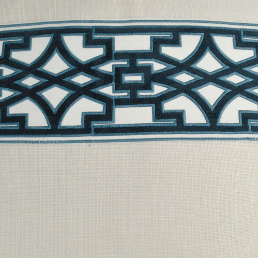Cream woven fabric with teal geometric lattice border and navy accents.