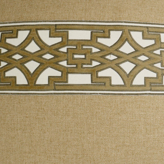 Beige textured fabric with a wide gold metallic Greek-key lattice band across.