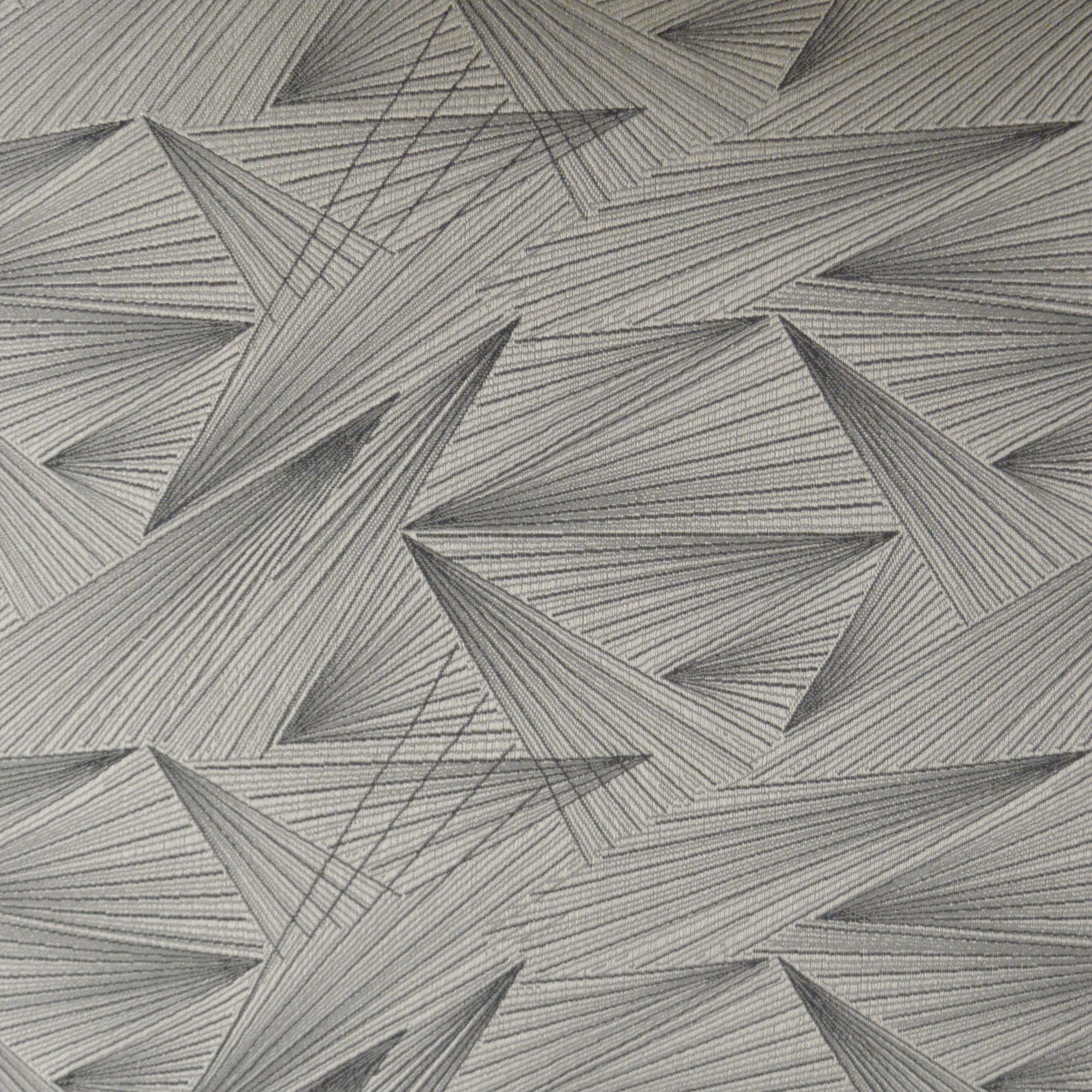 Gray pillow with a stitched triangular geometric pattern; quilted, upholstery-style.