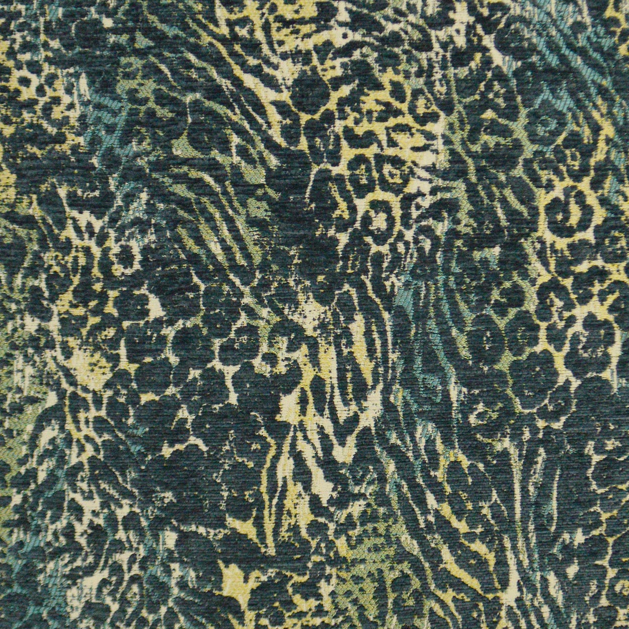 Teal & beige leopard print fabric on a 24" x 24" pillow, dark spots, woven upholstery material.