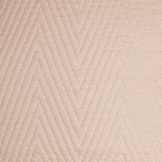 Beige chevron-pattern fabric with raised ridges; soft upholstery or rug material.