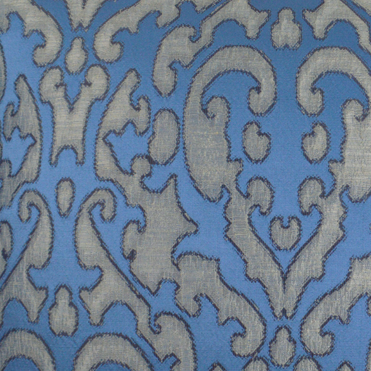 Blue fabric with light gray damask scrollwork pattern; ornamental upholstery or drapery textile.
