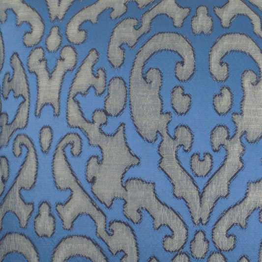 Blue fabric with light gray damask scrollwork pattern; ornamental upholstery or drapery textile.