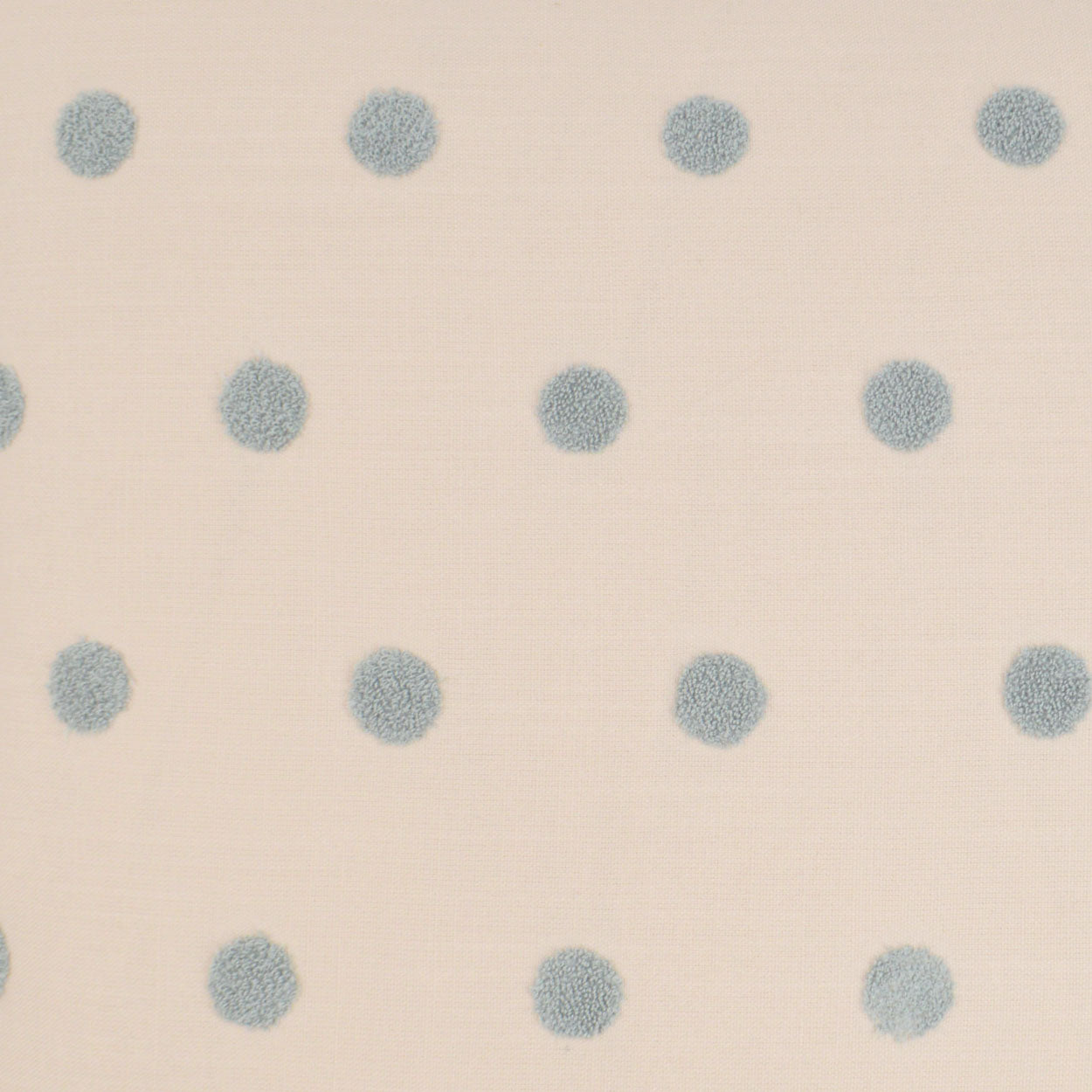 Cream fabric with evenly spaced pale blue polka dots, soft textile pattern for clothing or home decor.