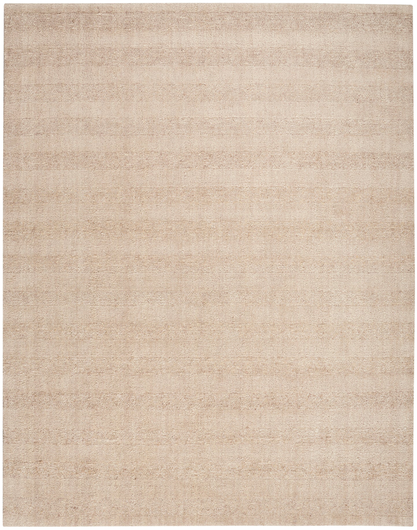 Beige rectangular rug with subtle tonal texture and soft woven finish; neutral living room floor covering.
