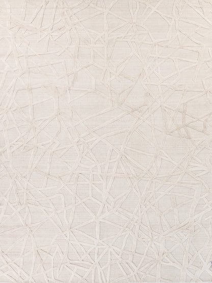 Beige rug with a subtle raised abstract network of irregular lines and linen texture.