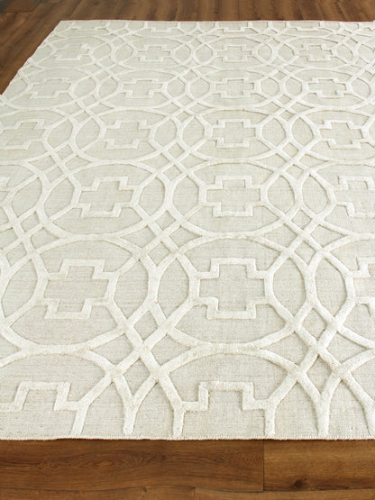 Ivory cream rug with a repeating interlocking circular lattice pattern in a textured weave on a wood floor.