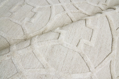 Cream textured geometric rug with raised pattern; plush woven fabric, perfect for living room decor.